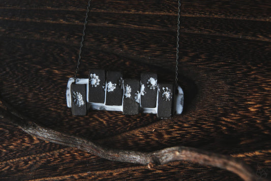 Pieces of the Tide / Black Ceramic Necklace with Seashell Iprints